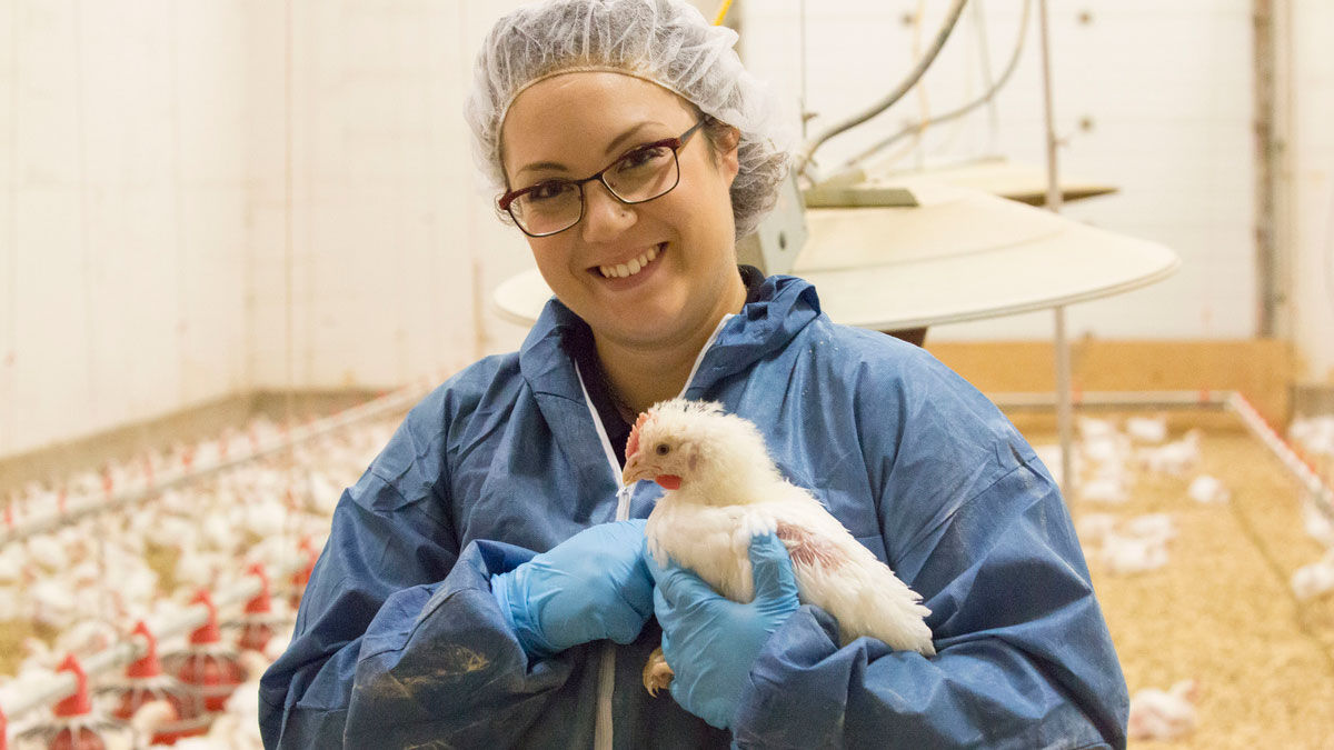 woman holding a chicken